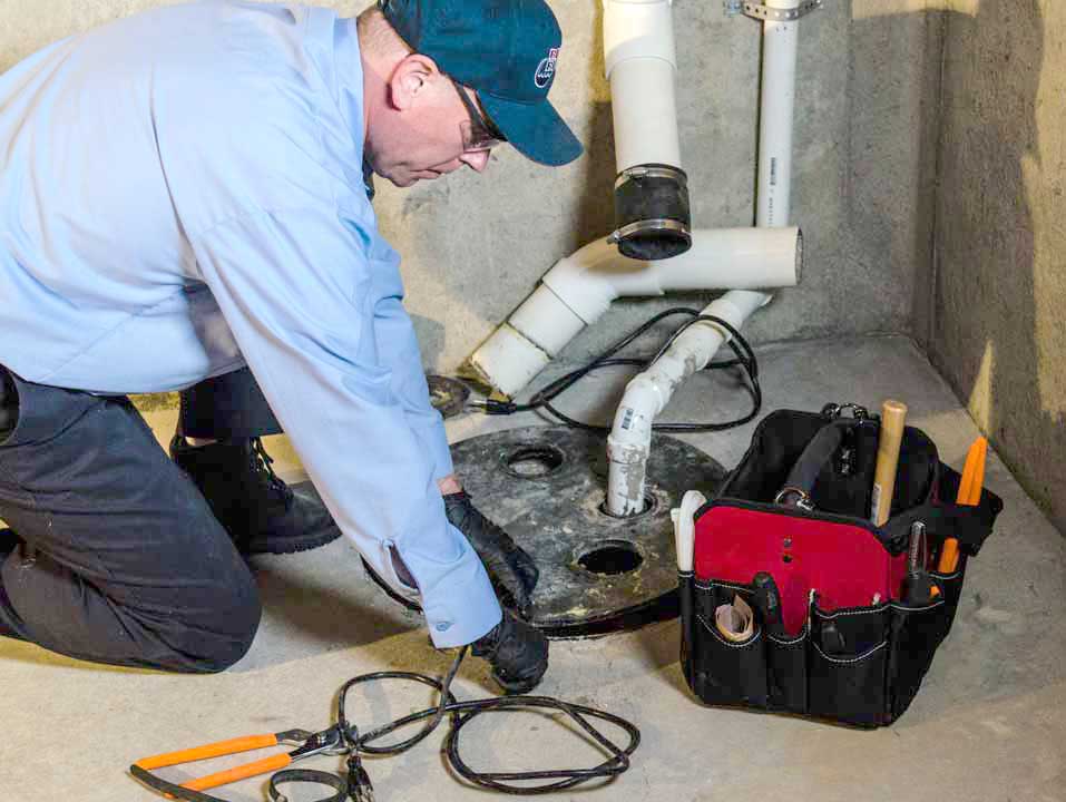 Plumber replacing sump pump